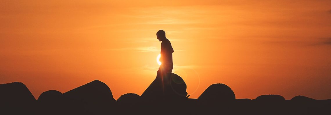 person standing on rock platform