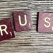 trust spelled with wooden letter blocks on a table